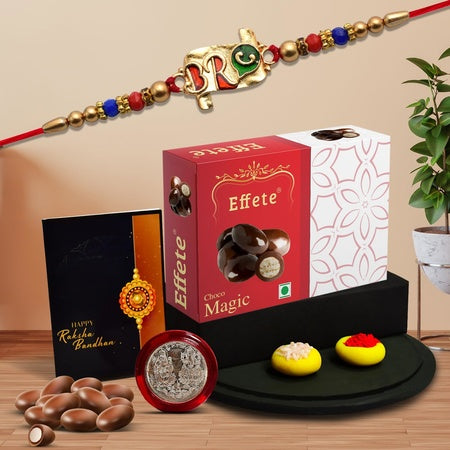 Rakhi For Brother Set Of 1 With Silver Color Pooja Coin Rakhi With Greeting Card Rakhi For Brother And Bhabhi Rakhi With Chocolate Rakhi For Kids Rakhi With Sweets (K1_553_em32) 200 Grams